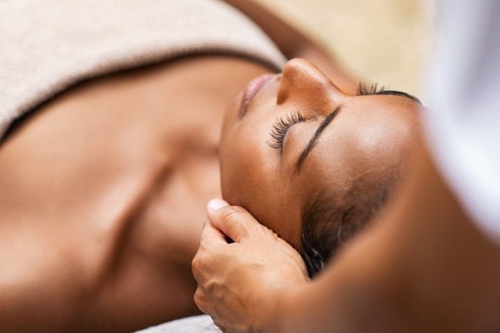 Client relaxing during a facial at SkinBarVII